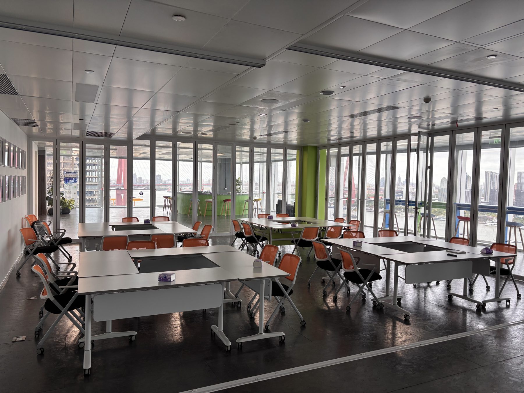 Workshop room with group tables overlooking the river